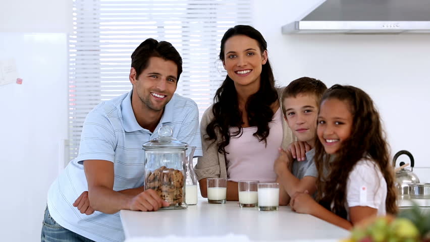 Family with some milk and cookies